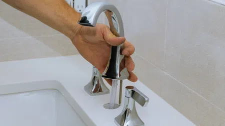 a hand holding a faucet in atlanta