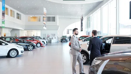 a car dealership owner shaking hands with someone