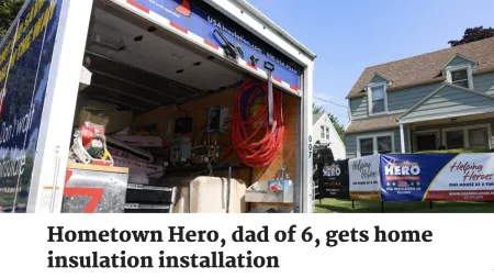 Open insulation service truck with equipment in front of a suburban home displaying Helping Heroes banners