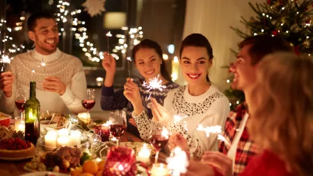 a group of people sitting around a table with food and drinks