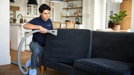 a person sitting on a couch reading a book