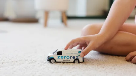 a person pushing a toy car