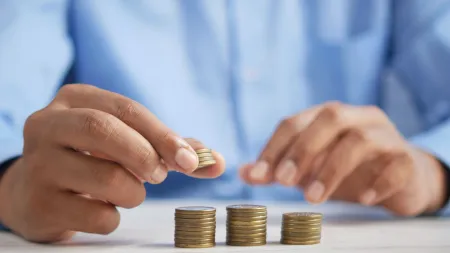 a close-up of hands holding coins