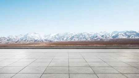 a large area of tiles with snow covered mountains in the background