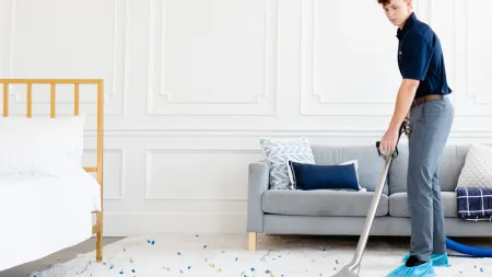 a man vacuuming a room