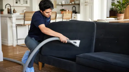 a person sitting on a couch reading a book