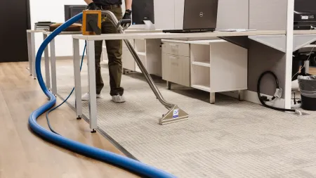 a person standing next to a desk