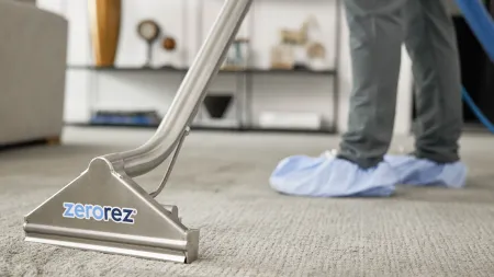 a person cleaning a carpet