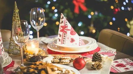 a table with a plate of food and glasses of wine