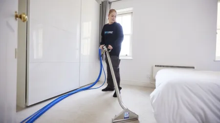 a person vacuuming a room