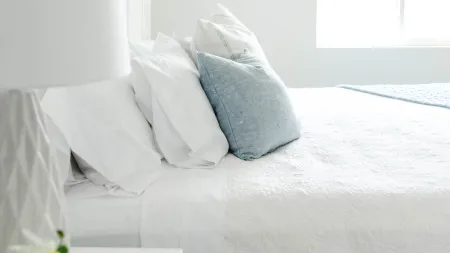 a bed with white sheets