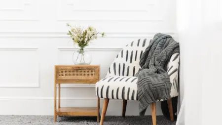 Chair on carpet with spring flowers for spring cleaning