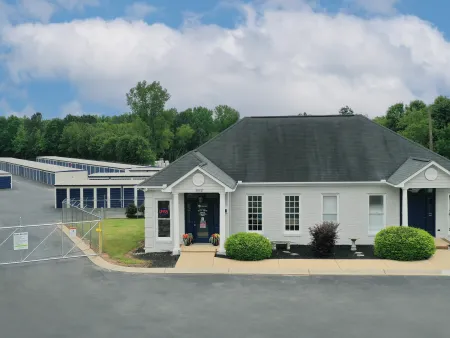 a white house with a fence around it