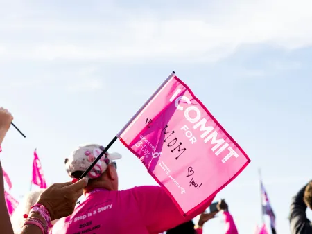 a person holding a pink sign