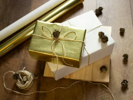 a white box with a gold ribbon