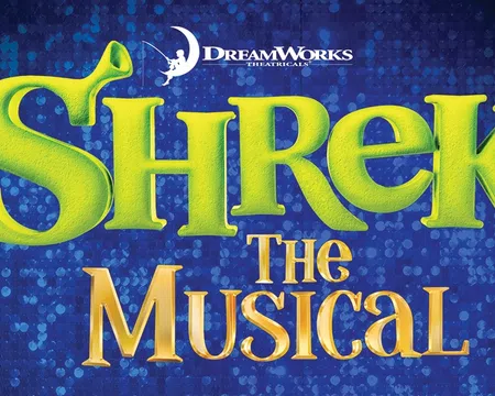 Shrek The Musical logo with green ogre ears integrated into the text on a blue textured background.