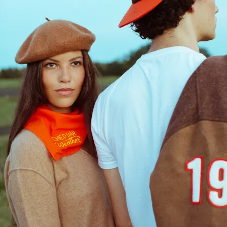 a man and woman standing next to each other and looking at the camera