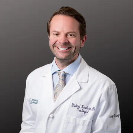 a man wearing a white coat and tie