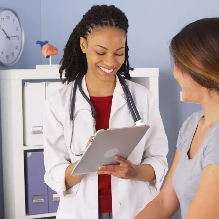 a doctor showing a patient something on the tablet