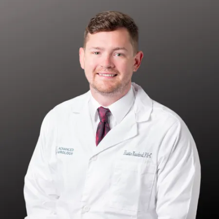 a man wearing a white coat and red tie