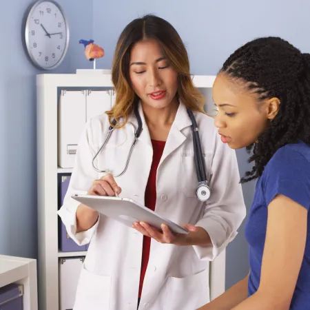 a doctor showing a patient something on the tablet