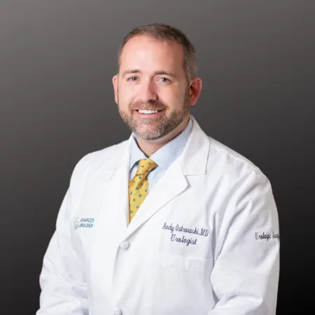 a man wearing a white coat and yellow tie