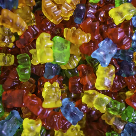 Colorful gummy bears in various shapes and sizes scattered together.
