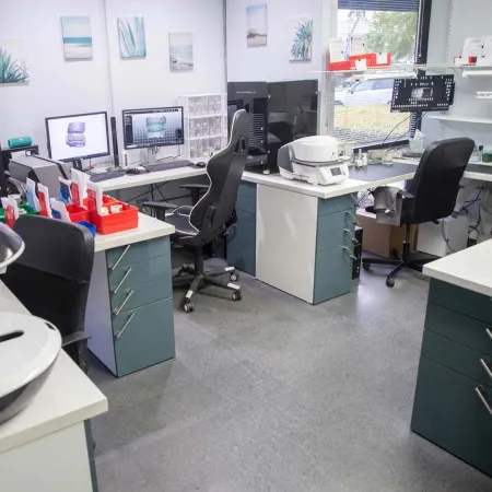 a room with computers and chairs