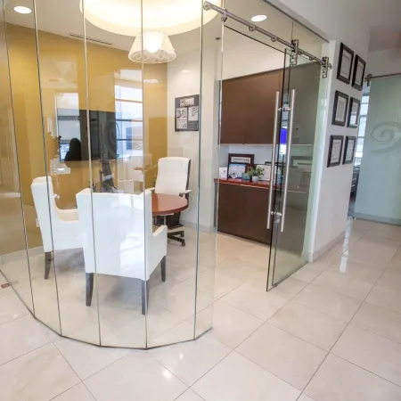 a room with glass doors and a table and chairs