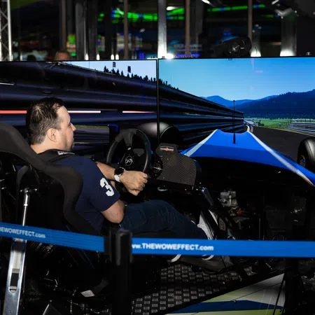 A gamer interacts with a racing simulator featuring a large multi-screen setup.