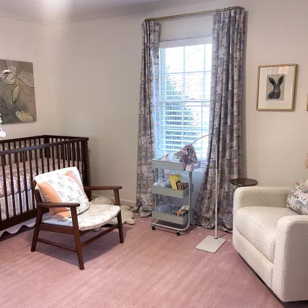 a room with a crib and a chair