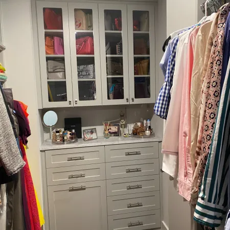 a closet with clothes and a mirror