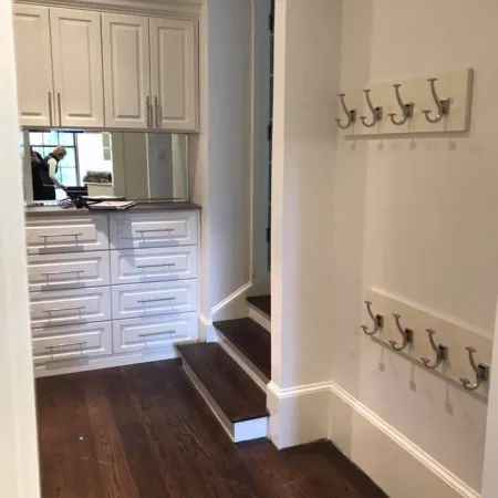 a bathroom with white cabinets