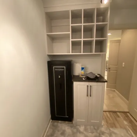 a room with a shelf and cabinets