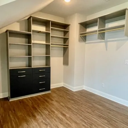 a room with shelves and a wood floor