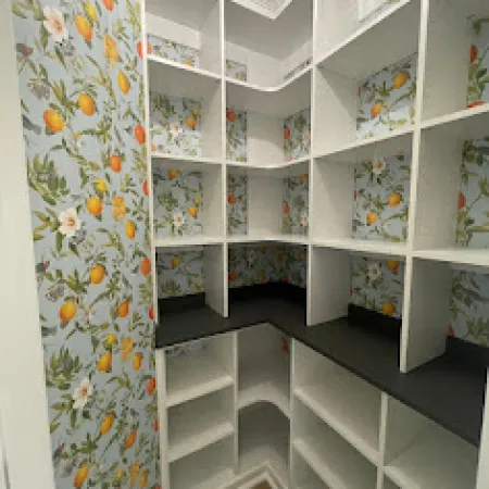 a white shelving unit with many items on it