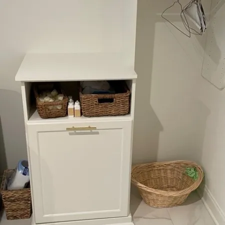 a white cabinet with baskets and baskets