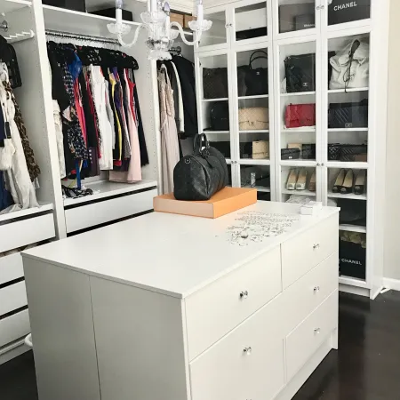 a white cabinet with a white top and a black bag on top