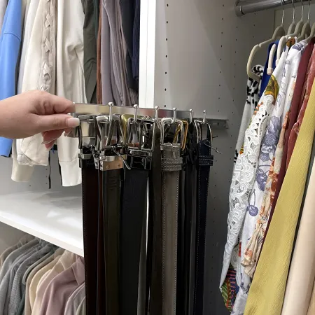 a person holding a rack of clothes