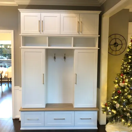 a white cabinet with a clock on top