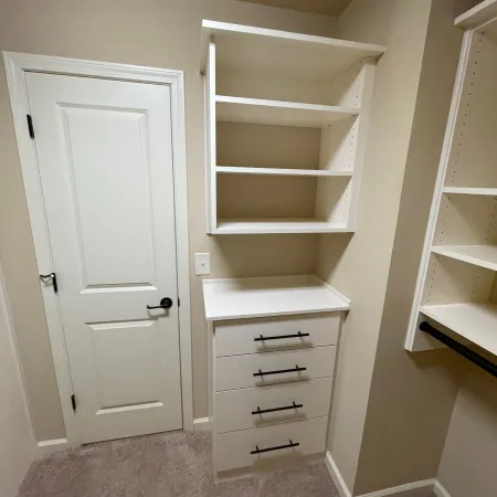 a white closet with a white door