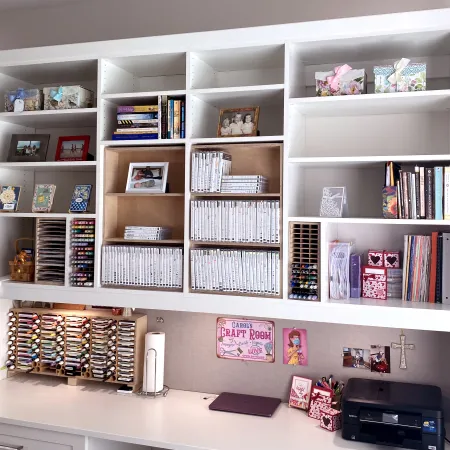 a white shelving unit with books