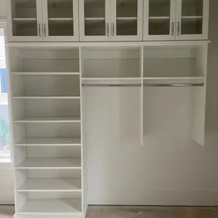 a white cabinet with glass doors