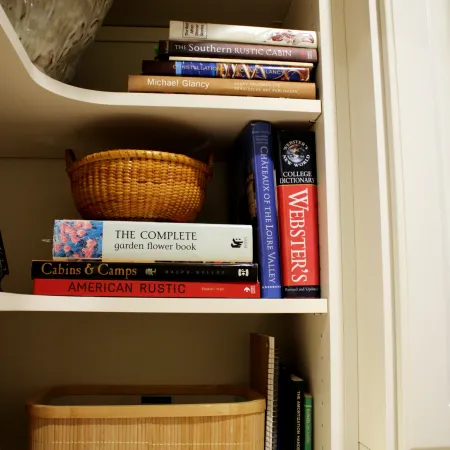 a shelf with books and a basket