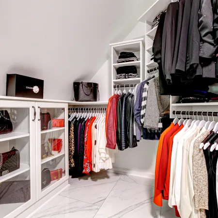 a closet with clothes and shoes