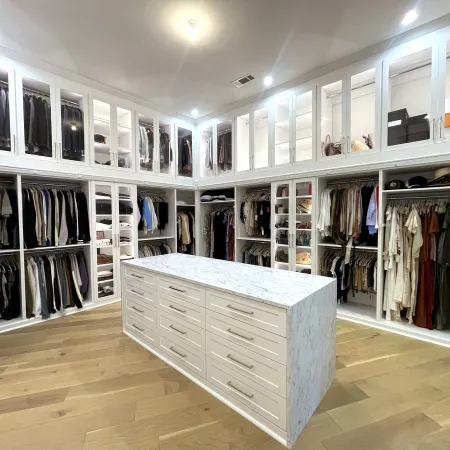 a white room with a white counter and white cabinets