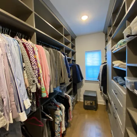 a room with a closet full of clothes