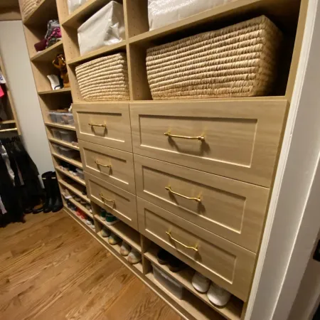 a white dresser with baskets on it