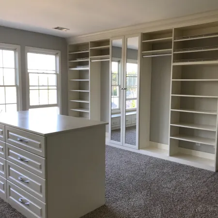 a room with white cabinets and a counter top