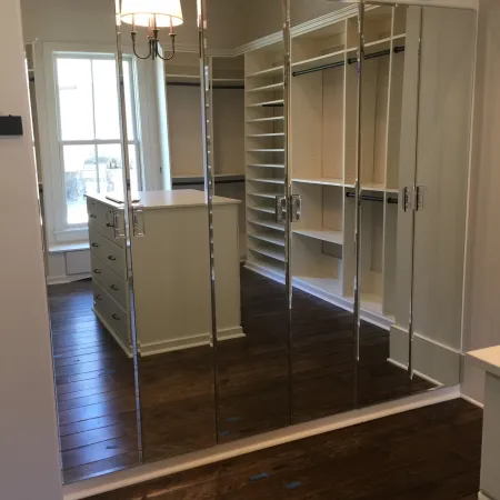 a room with a glass door and a metal cabinet with a light